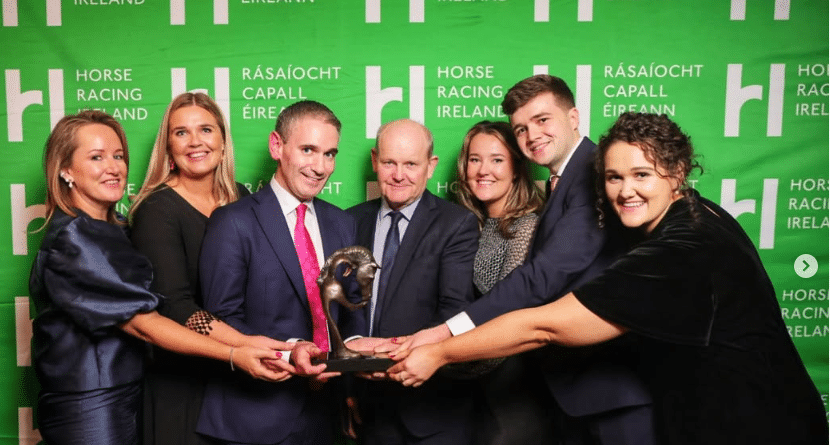 group of smiling people accepting an award